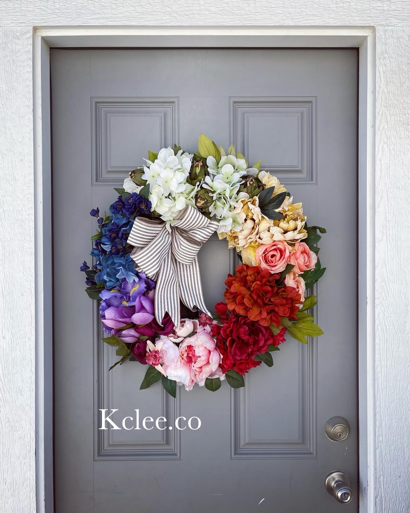 Welcome wreath - Colorful & cheery 26” super full top wreath! Very luxe materials. Lacquered coated wood center.